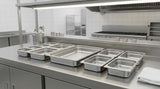 Full-size and fractional food pans arranged for different buffet menu volumes