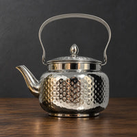 Silver Lily Style C teapot with a hammered body, metal swing handle and pointed lid finial