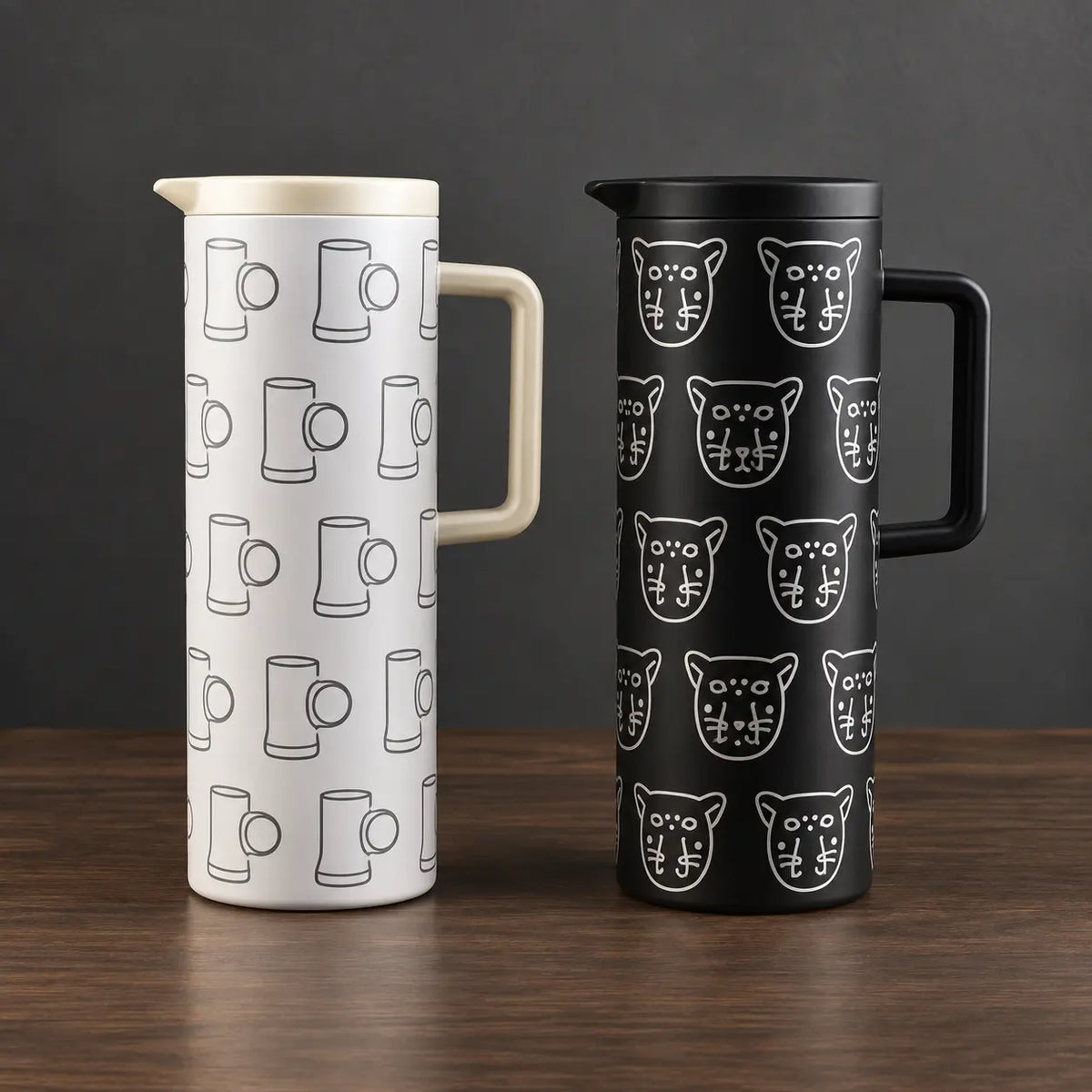 Black and white one-liter iron-shell thermos bottles with repeating graphic patterns, fitted lids, and side handles