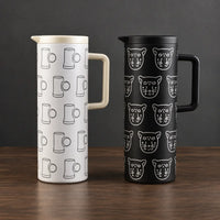 Black and white one-liter iron-shell thermos bottles with repeating graphic patterns, fitted lids, and side handles