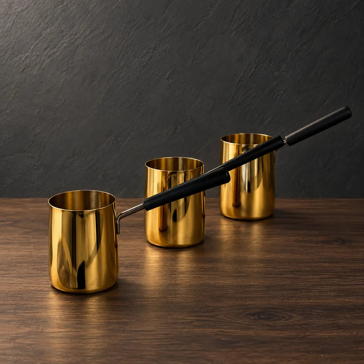 Gold stainless steel milk cups with black handles and optional lids