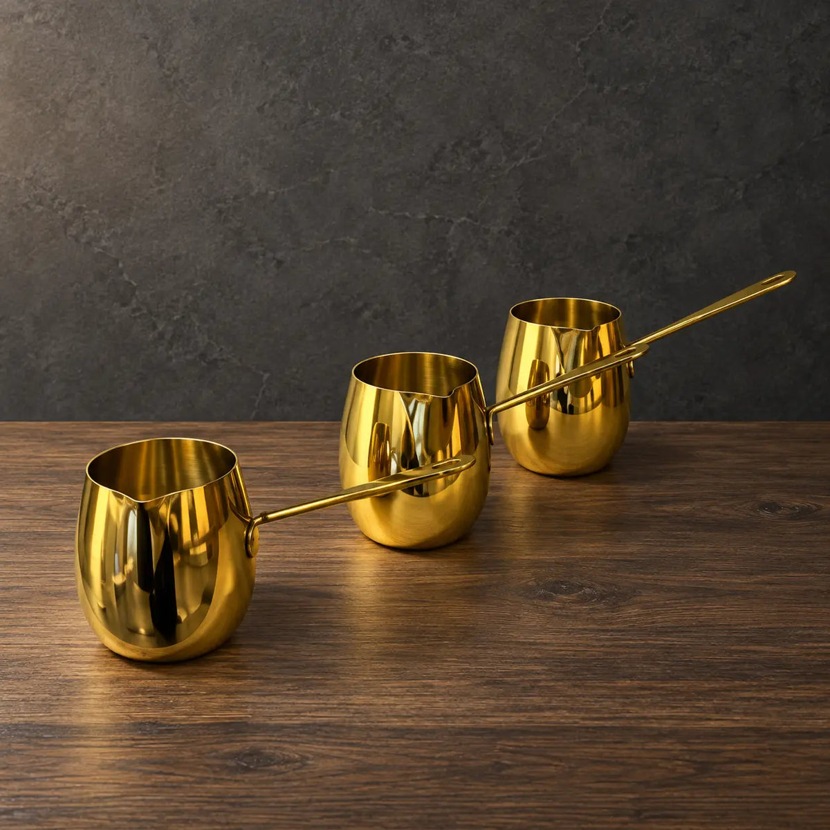 Gold drum-shaped stainless steel milk cups with matching metal handles