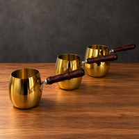 Gold drum-shaped stainless steel milk cups with wooden handles