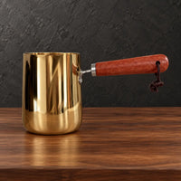 Gold stainless steel milk cups with natural wooden handles and lids