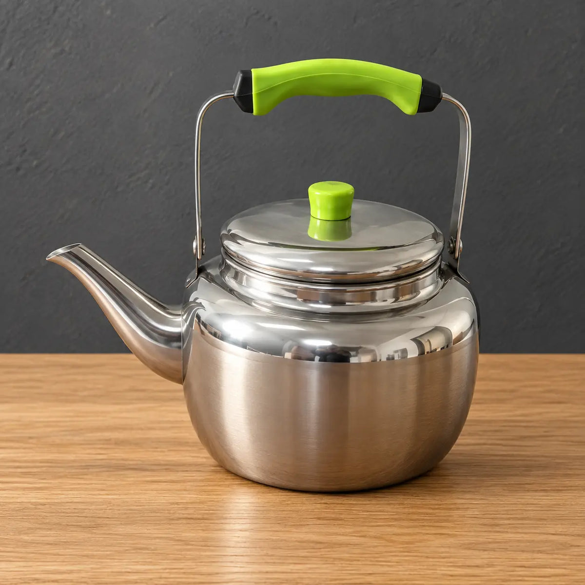 Polished Lily stainless steel teapot with a green silicone handle grip and green lid knob