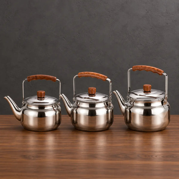 Three polished Lily teapots in graduated sizes with brown handle grips displayed above a green product box