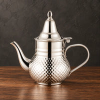 Silver Moroccan kettle with a dotted lower body, conical lid, open ring finial and curved spout