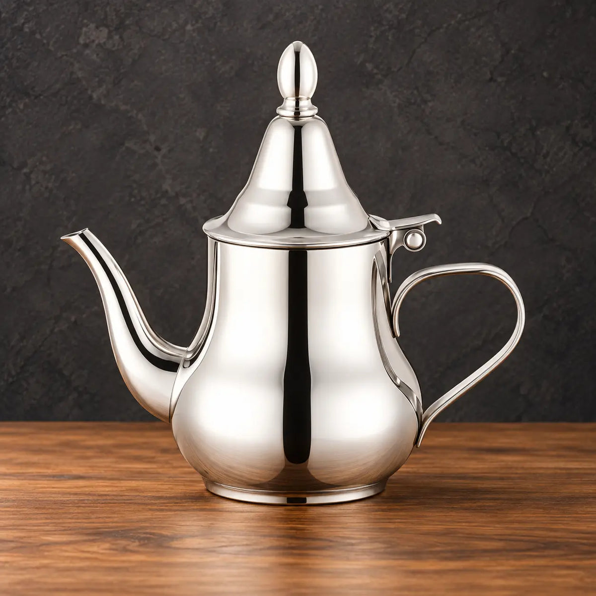 Silver smooth-finish Moroccan kettle with a conical lid, open ring finial, curved spout and side handle