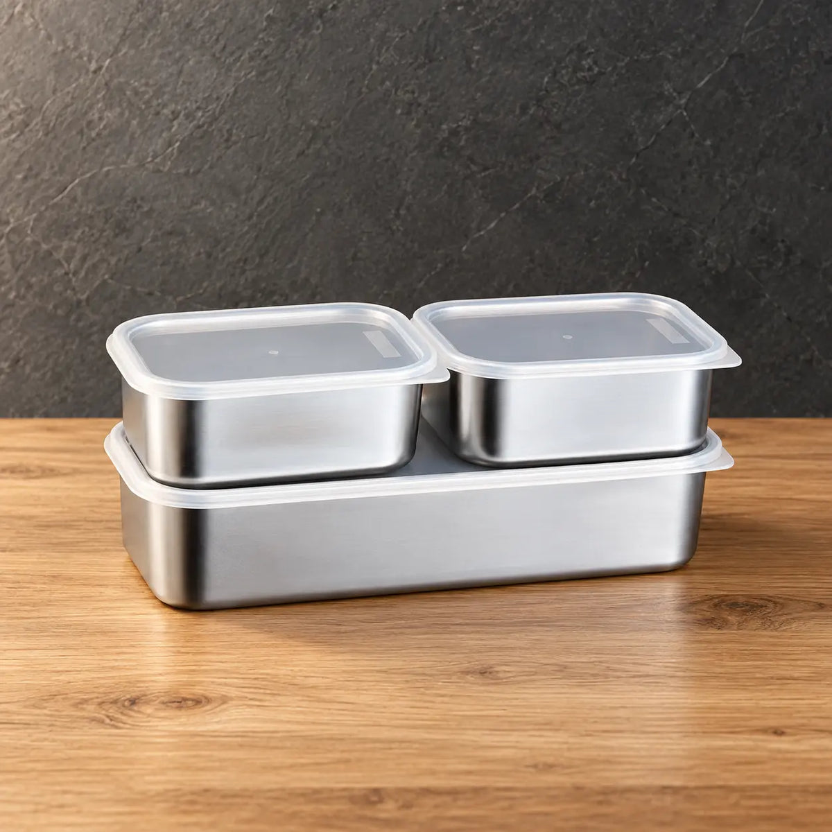 Rectangular food storage container set with two lidded boxes above a deeper base container