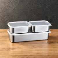 Rectangular food storage container set with two lidded boxes above a deeper base container