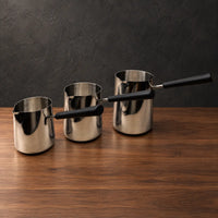 Silver stainless steel milk cups with black handles and optional lids