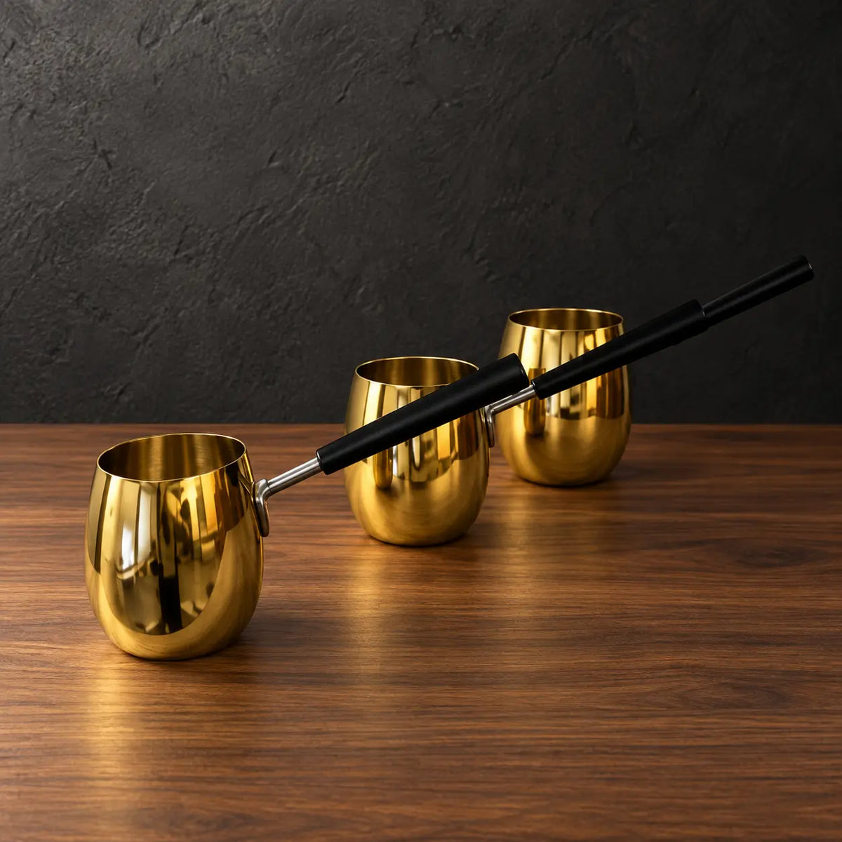 Silver drum-shaped stainless steel milk cups with black handles