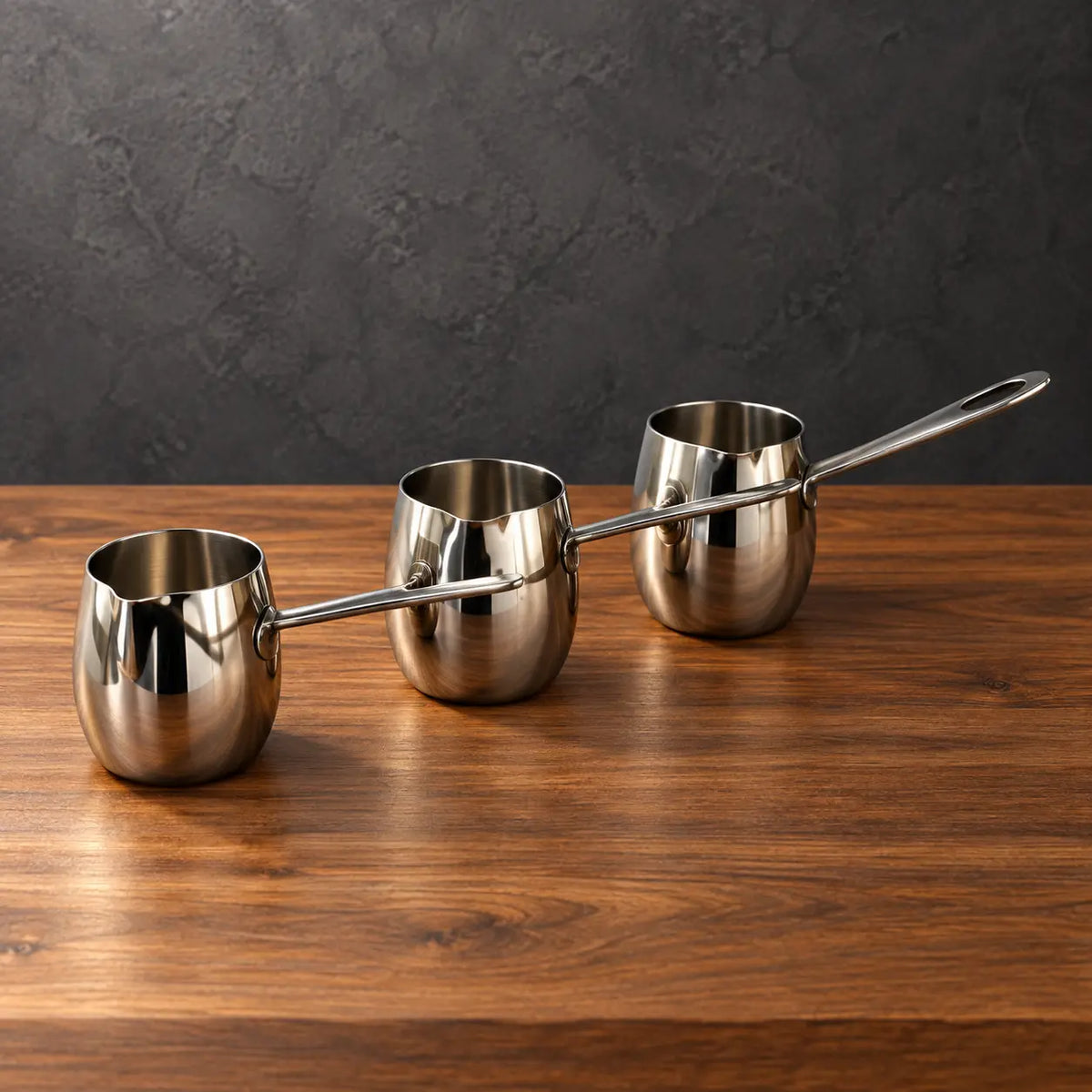 Silver drum-shaped stainless steel milk cups with polished steel handles