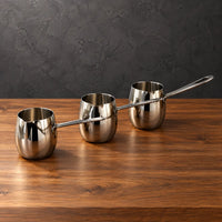 Silver drum-shaped stainless steel milk cups with polished steel handles