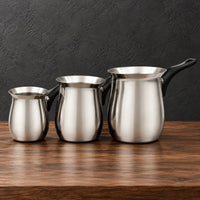 Spouted stainless steel milk cups with black Bakelite handles and lids