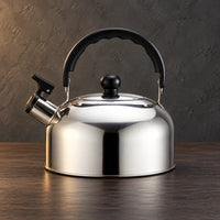 Thin polished silver whistling teapot with a low wide body, black arched handle, and black lid knob