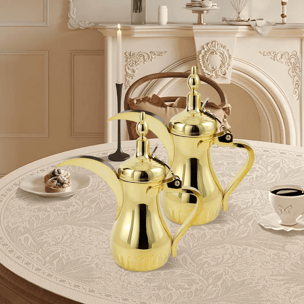 Gold stainless steel Arabic Dallah coffee pot with a traditional curved spout for hotel and hospitality coffee service.
