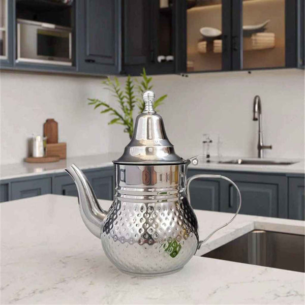 Mirror-polished Moroccan stainless steel teapot with a long pouring spout and built-in infuser for hospitality tea service